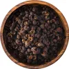 A top-down view of Szechuan peppercorns in a wooden bowl. Produktbild-Vorschau