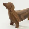 A wooden figurine of a dachshund dog. Produktbild-Vorschau