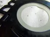 A close-up view of a black plastic component with a light gray ring and a white fibrous material inside. There are several small, circular indentations on the white material. Anteprima dell’immagine prodotto