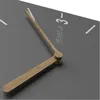 A close-up view of a modern wall clock with wooden hands and gray face. Anteprima dell’immagine prodotto