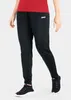 A person wearing black polyester pants and a red shirt. Produktbild-Vorschau