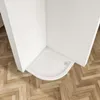 A white quarter-circle shower tray is installed in a corner of a bathroom with wooden parquet flooring. Produktbild-Vorschau