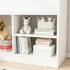 A close-up view of a white bookshelf filled with children's books and stuffed animals. Náhled obrázku produktu