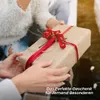 Two people are holding a wrapped gift with red ribbon and berries. Podgląd zdjęcia produktu