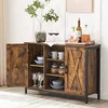 A rustic-style wooden sideboard with glass doors and shelves, containing various items like bottles, glasses, and bowls. Náhled obrázku produktu