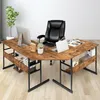 An L-shaped desk with a black office chair and a computer setup. Podgląd zdjęcia produktu