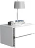 A white nightstand with two drawers, a lamp, and a clock on top, set against a white background.
