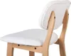 A close-up view of a white upholstered bar stool with light wood legs and back support, isolated on a white background. Produktbild-Vorschau
