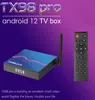 A marketing image for a TX98 pro Android 12 TV box, showing the device and its remote control against a gradient purple and blue background. Podgląd zdjęcia produktu