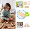 A young child is playing with a wooden train track set on the floor, with a toy piano in the background. The image also includes product packaging and close-ups of the train tracks. Produktbild-Vorschau
