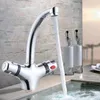 A chrome faucet with water flowing into a tub, with two decorative bottles in the background. Produktbild-Vorschau