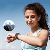 A woman is looking at her smartwatch while outdoors. Náhled obrázku produktu