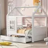 A child's house-shaped bed with drawers, decorated with snowflakes and fairy lights. Voir les images du produit