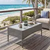 A coffee table on a wooden deck overlooking a beach and ocean. Produktbild-Vorschau