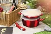 A picnic setting with cookware and a picnic basket. Produktbild-Vorschau