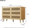 A diagram illustrating the dimensions of a wooden dresser with rattan drawer fronts and wooden legs. Anteprima dell’immagine prodotto