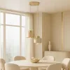 A modern dining room with a pendant light fixture over a round table. Produktbild-Vorschau