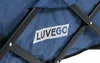 A close-up view of the fabric of a dark blue cart with a white label that says "LUVEGO" in blue text. The cart's black metal frame is visible. Produktbild-Vorschau
