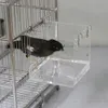 A bird is inside a cage, interacting with a transparent acrylic box attached to the cage. Produktbild-Vorschau