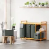 A bathroom setting with a laundry organizer. Voir les images du produit