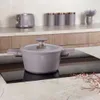 A taupe Berlinger Haus pot with a glass lid sits on a black induction stovetop, with kitchen cabinets and appliances in the background. Voir les images du produit
