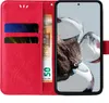 A red flip phone case with card slots and a euro banknote is shown next to a smartphone displaying an image. Produktbild-Vorschau