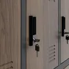 Close-up view of a locker door with a key inserted into the lock. Anteprima dell’immagine prodotto