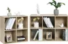 Two modular shelving units filled with books, decorative items and pictures. Produktbild-Vorschau