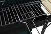 Close-up view of a charcoal grill's grate and side shelf. Produktbild-Vorschau