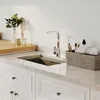 A modern kitchen sink area with a faucet, countertop, and cabinetry. Produktbild-Vorschau