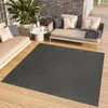An outdoor patio with furniture and a rug. Produktbild-Vorschau