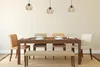 A dining room set with a wooden table, chairs, and a bench, illuminated by pendant lights. Náhľad obrázku produktu
