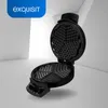 A black waffle iron with its lid open, showing the heart-shaped waffle molds. The product is placed on a light gray surface with a white background. Produktbild-Vorschau