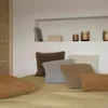 Several fluffy throw pillows are arranged on a bed with a textured wall and shelf in the background. Produktbild-Vorschau