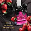 A bottle of Juicy Couture Viva La Juicy Noir perfume is surrounded by strawberries, a blackberry, and a blueberry, set against a black tulle background. Text overlays the image. Podgląd zdjęcia produktu