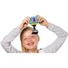 A young girl is holding a toy trophy above her head. Voir les images du produit