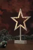 A decorative LED star with lights on a stand, placed on a wooden surface with festive decorations in the background. Produktbild-Vorschau