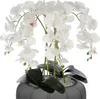 A white artificial orchid arrangement in a dark gray pot. Voir les images du produit