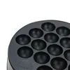 A close-up view of a black takoyaki maker with multiple hemispherical indentations. Náhled obrázku produktu