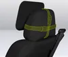 A black car seat with a headrest and a separate pillow attached with green straps. Produktbild-Vorschau