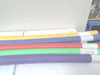 Several colorful swimming noodles are laid out horizontally on a white surface. Produktbild-Vorschau