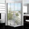 A modern bathroom with a glass shower enclosure featuring a scenic beach and dune grass image. Produktbild-Vorschau