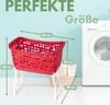 A red laundry basket with white legs is shown in front of a washing machine, with dimensions indicated by text overlays. Produktbild-Vorschau