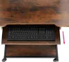 Close-up view of a desk with a keyboard on a pull-out tray and a second shelf below. Náhled obrázku produktu
