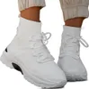A pair of white high-top sneakers worn by a person. Produktbild-Vorschau