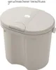 A light gray Rotho Babydesign TILO Cappuccino diaper pail with its lid closed, shown from a slightly elevated front-left angle against a white background. Produktbild-Vorschau
