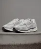 A pair of white Nike sneakers on a concrete surface. Produktbild-Vorschau