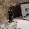 A desk scene with a laptop and a pen holder. Produktbild-Vorschau