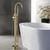 A modern bathroom with a freestanding bathtub and a gold floor-standing faucet. Produktbild-Vorschau