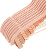 A close-up view of stacked pink velvet hangers with rose gold clips. Produktbild-Vorschau